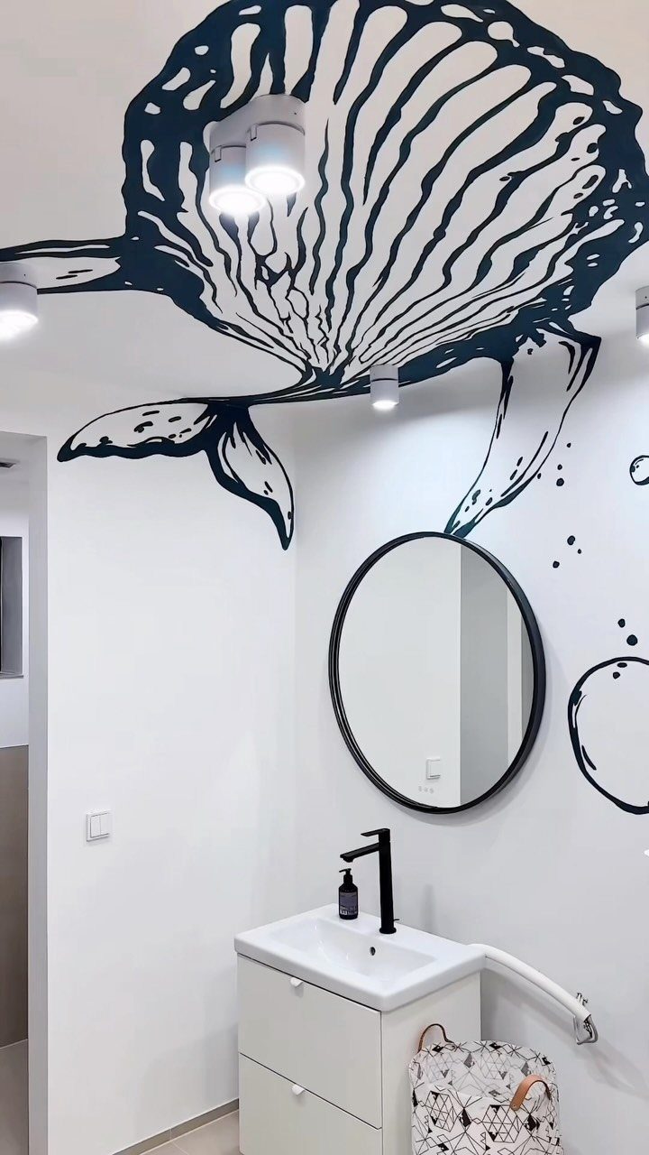 9 Bathroom Mural Ideas for Every Style and Space 6 Black line-art whale mural on a white bathroom wall and ceiling.