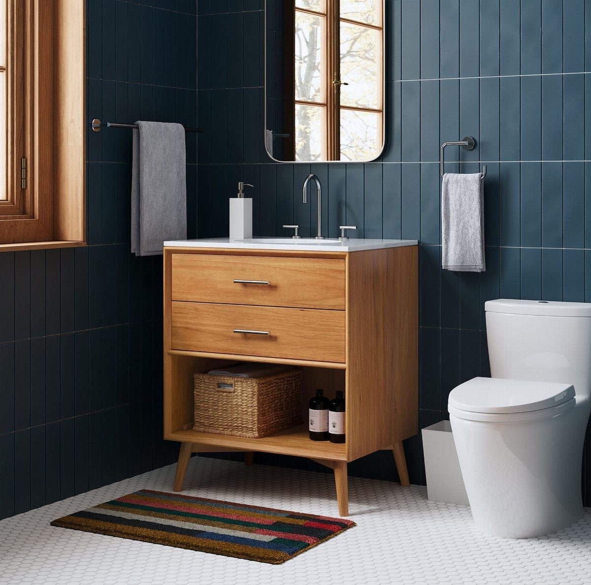 Wooden bathroom vanity with open bottom shelving containing a wicker storage basket.